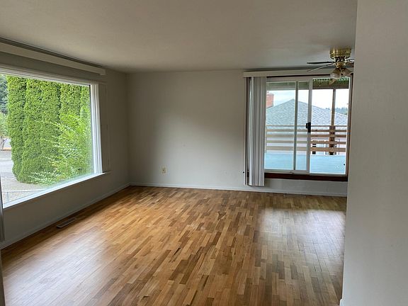 main floor living/dining room with sliding door to large deck