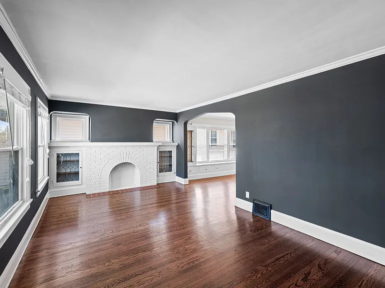 This photo shows the living room and its decorative fireplace.