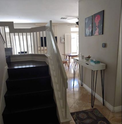 Entrance and stairways going upstairs - Floors are travertine and stairs are wood