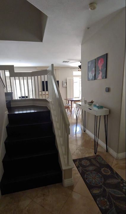 Entrance and stairways going upstairs - Floors are travertine and stairs are wood