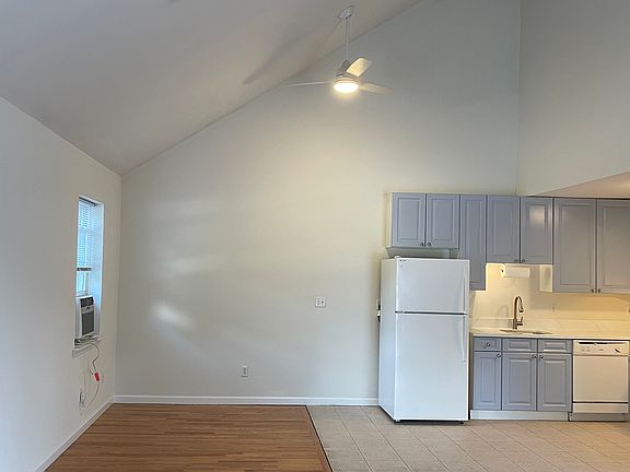 Your dining area is to left of the full-sized Frigidaire refrigerator and well-appointed kitchen. Cabinets are freshly painted.