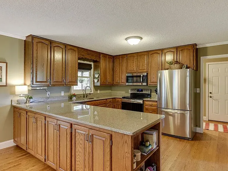 Kitchen with stainless steel appliances and access to 2-car garage
