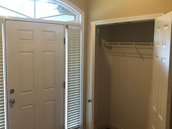 View of front door and large coat closet