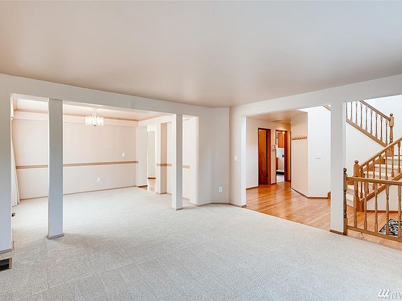 This photo shows the entry, living room and adjoining dining room. All new carpet thru out the home.