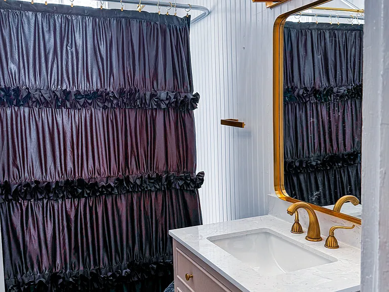 Stunning new bathroom renovated with clawfoot tub and gilt faucets and crystal and gilt lighting.