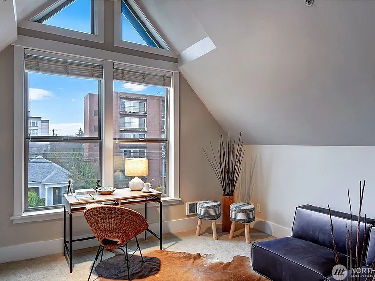 This top-floor bedroom makes a great flex space for whatever you need. The vaulted ceiling gives the space lots of volume.