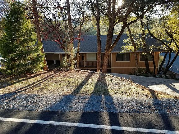 View of home from street with parking space foe one smaller vehicle