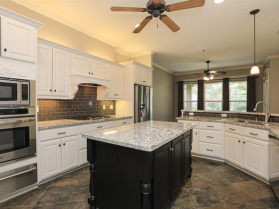 Stainless appliances includes a warming drawer! New light granite and the white cabinets really makes it light and bright! Slate floors are great for maintenance and easy to clean! Especially good with kids and pets!