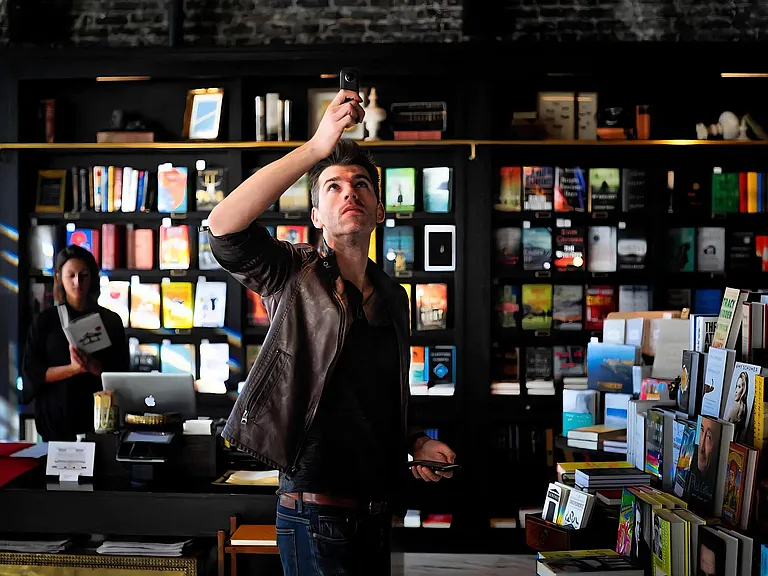 Bookstore Scene Featuring Tall Shelves and Dark Wood Shelving