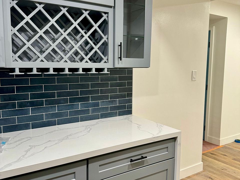 Shaker custom cabinetry complements the chef's kitchen and adjacent dining room.