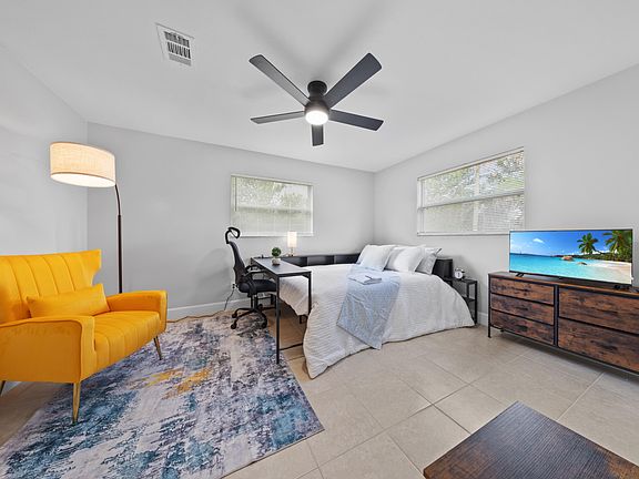 Natural light, ceiling fan, area rug a real bedroom, not just a place to sleep.