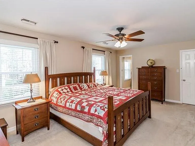 Master Bedroom - Right door leads to walk-in closet. Left door leads to master bathroom. Windows face front of house.