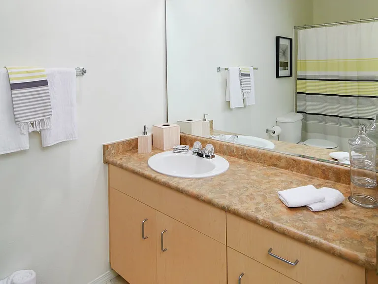 Classic Package I bath with oak cabinetry, laminate countertops, and hard surface flooring