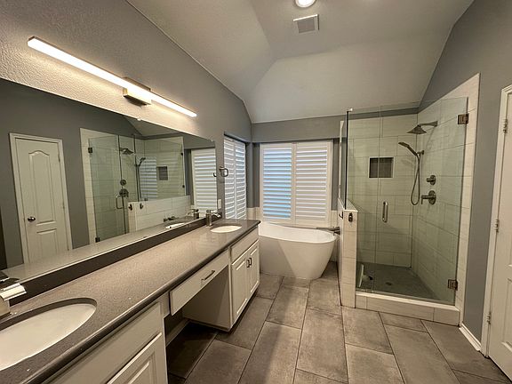 Gorgeous recently updated primary bathroom with a soaking tub and spacious shower.