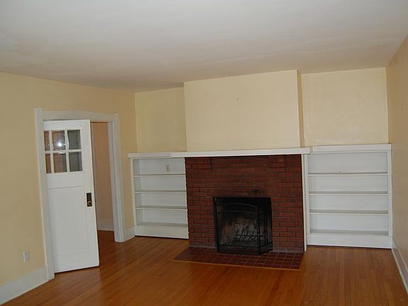 Living room with working fireplace and built in shelves