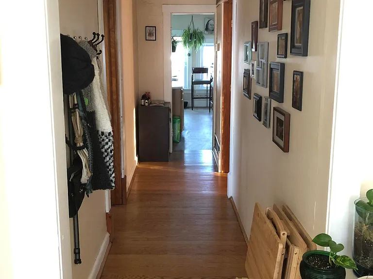 front hallway from living room. One bedroom on each side of the hallway, kitchen at the end of the hallway