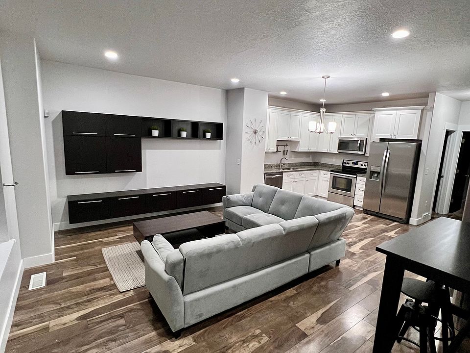 Second Floor: Spacious Living Room that features entertainment cabinetry and bright lighting