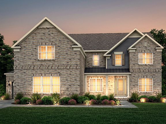 Sutton Exterior 25 features brick, hardie siding, covered front porch and 3 car sideload garage