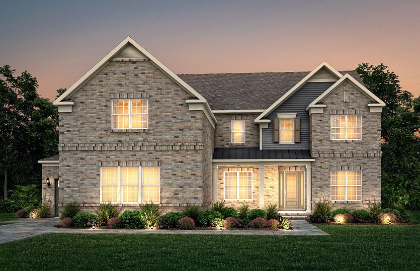 Sutton Exterior 25 features brick, hardie siding, covered front porch and 3 car sideload garage
