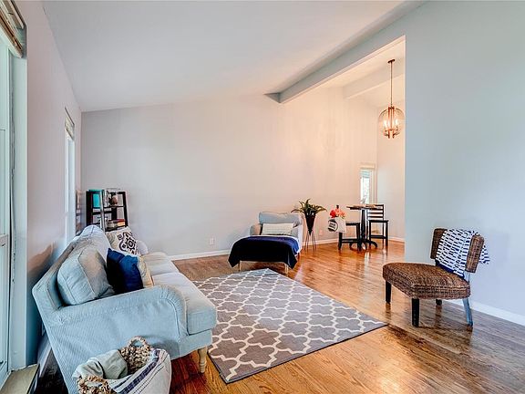 Inviting, open layout w/ vaulted ceiling and hardwood floors.