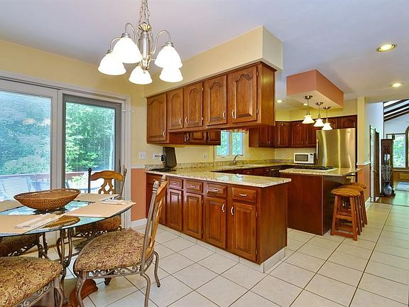 Large eat in kitchen with an island. Gas cooking, granite, and stainless.