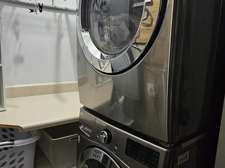 The washer and dryer is located just outside the backdoor in the garage storage area. There is plenty of hamper and hanging space.