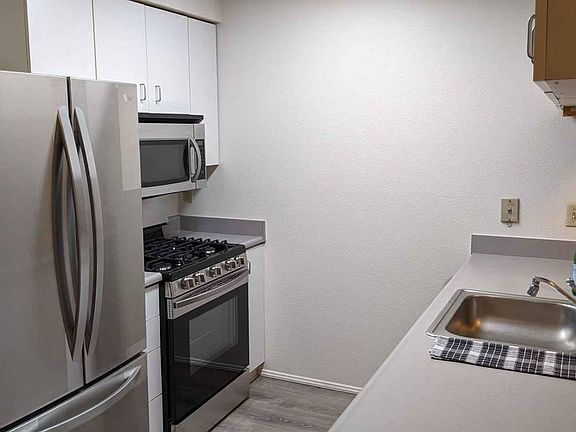 01 Unit Kitchen with counter open to the living room