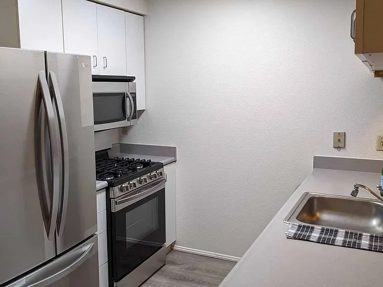 01 Unit Kitchen with counter open to the living room