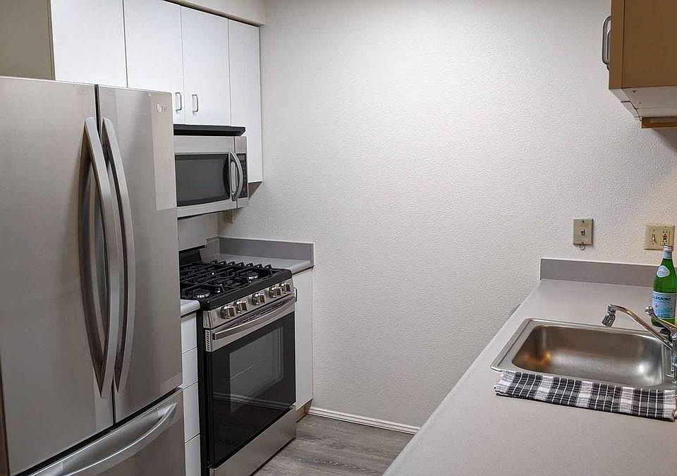 01 Unit Kitchen with counter open to the living room
