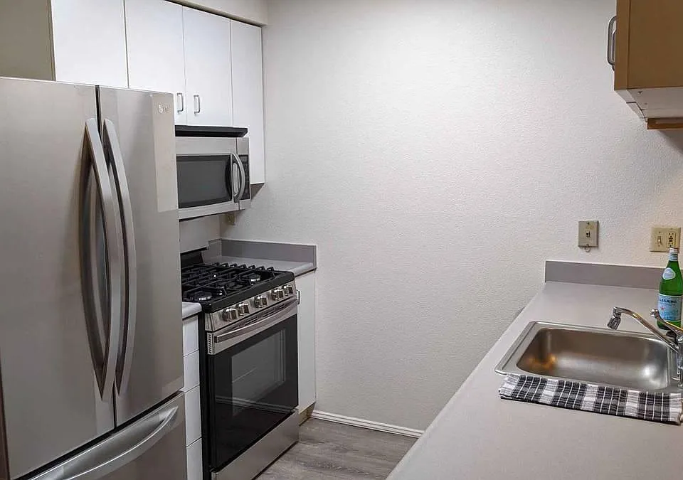 01 Unit Kitchen with counter open to the living room