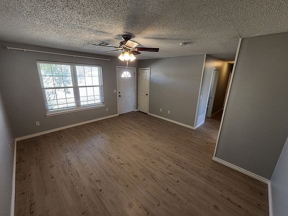 Living room looking toward front door and hall