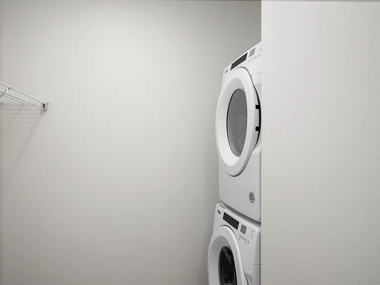 Modern laundry area featuring sleek stacked washer and dryer with ample storage space. Modern laundry area featuring sleek stacked washer and dryer with ample storage space.