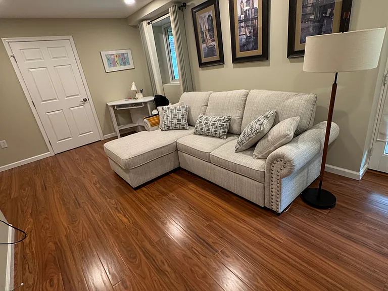 Living room fully furnished with brand new sectional queen sized sofa bed, equipped with storage & chargers on each end of sofa. Corner desk, curtains & blackout window treatment,