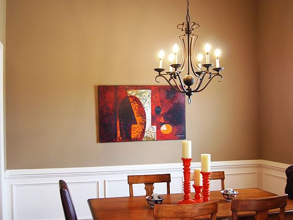 Dining room with decorative crown, shadow boxes and chair rail.