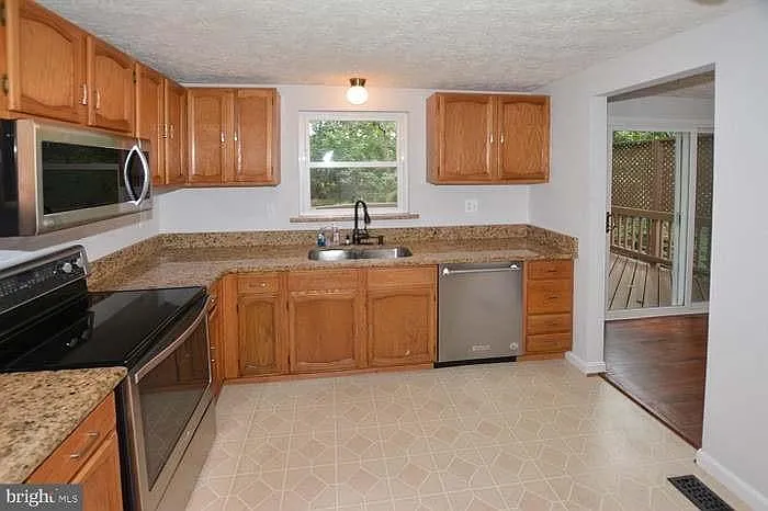 Kitchen, view from hallway at top of stairs.
