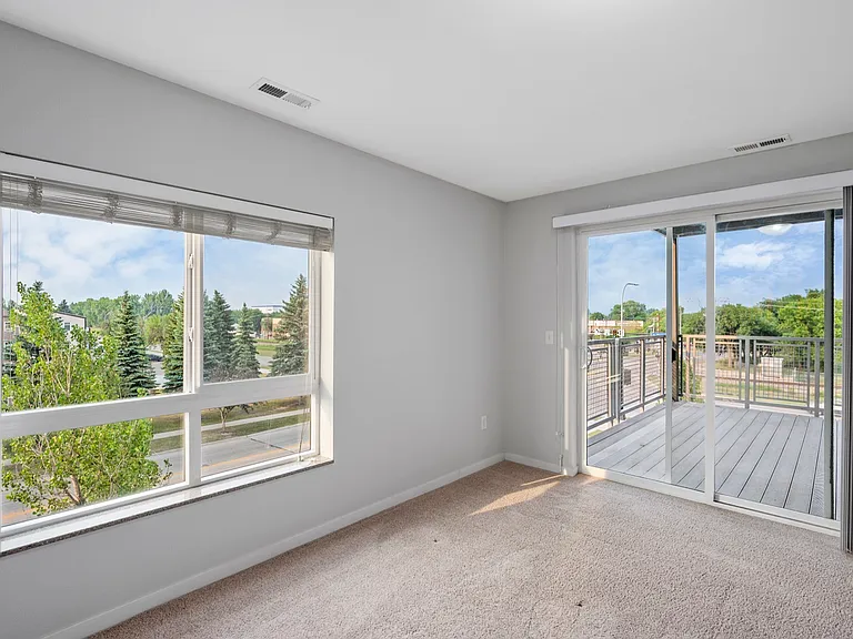 Bright and inviting room featuring large windows with scenic views, opening onto a spacious balcony perfect for relaxation. Bright and inviting room featuring large windows with scenic views, opening onto a spacious balcony perfect for relaxation.