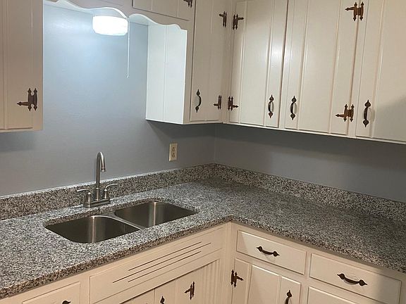 Kitchen with granite counter tops, washer and dryer