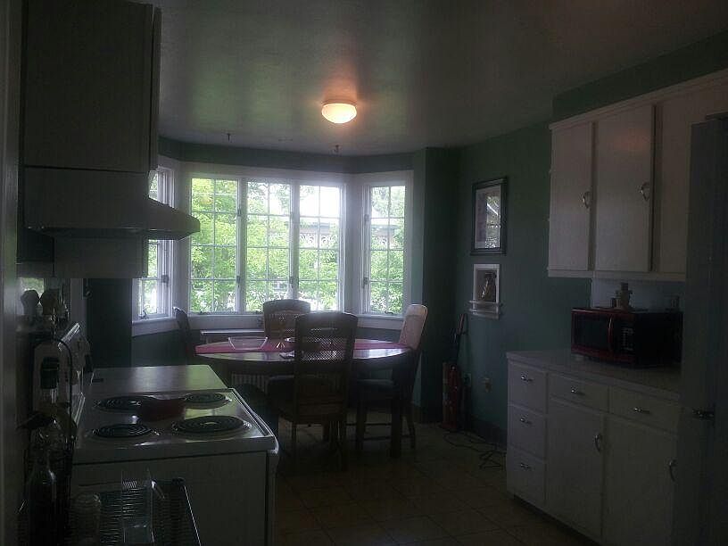 Large eat in kitchen with fantastic breeze from bay windows! New flooring being installed now. Ceiling fan is also installed.