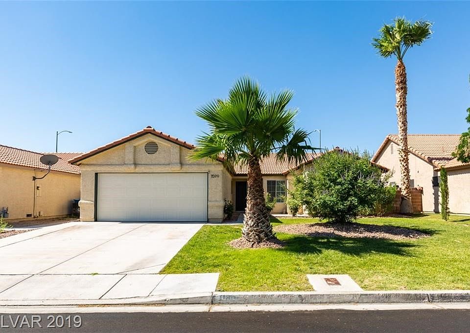 Exterior Front with green grass, palms and additional NEW plantings!