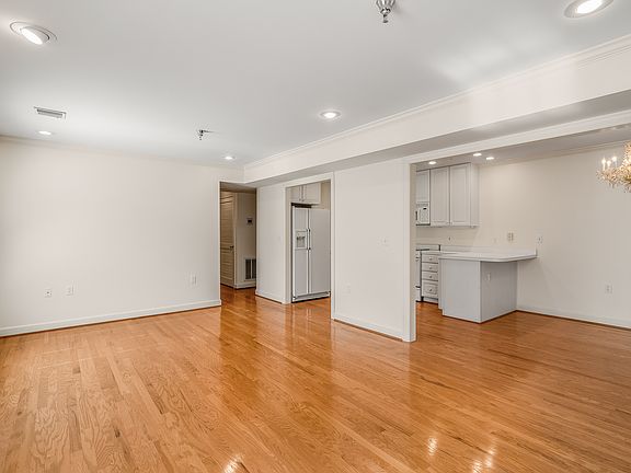 Living room. Pantry cabinet is on the other side of wall in the middle facing the kitchen. Hall closet is right down hallway to the left.