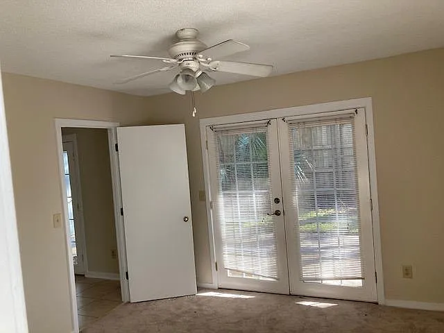 Main Bedroom w/French Doors opening to the fenced-in backyard and patio
