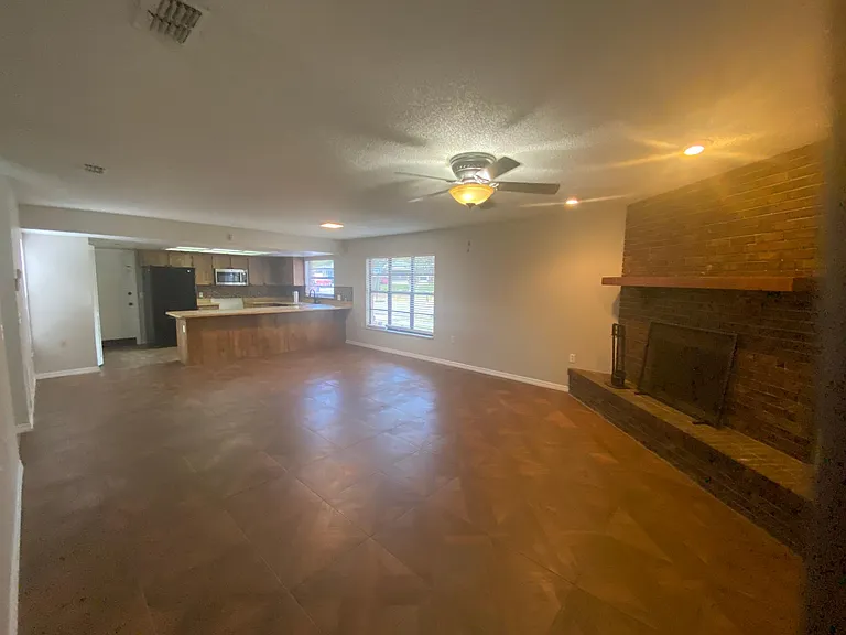 Extra large den area with wood burning brick fireplace