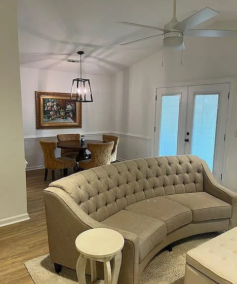 Spacious living room with french doors onto the patio. Family size table and chairs in the dining area comfortably seats four people.