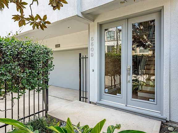 Enter through a gated courtyard with lush landscaping.