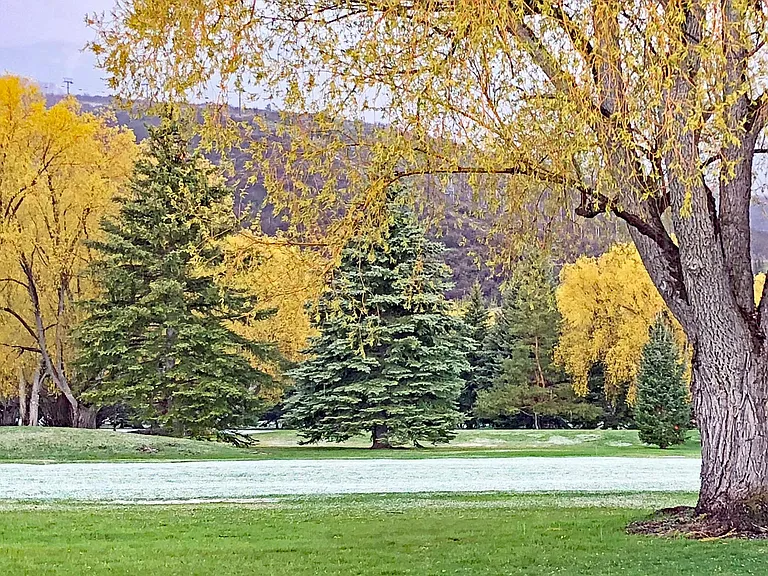 The view from the back patio of the 18th fairway and mountains in spring. The next photo has a similar view in winter.