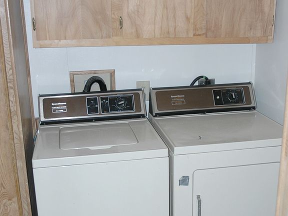 Laundry room is next to the kitchen.