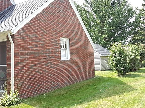NORTH END OF HOUSE SHOWING GARAGE AND STORAGE SHED