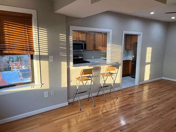 Living room w/ view into kitchen