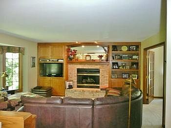 Warm and cozy family room with gas-log fireplace and built-ins!