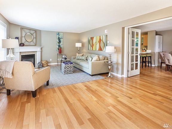 Spacious living room open to dining area/kitchen. Great for entertaining! Hardwood floors on main level, gas fireplace, French doors for lots of light.